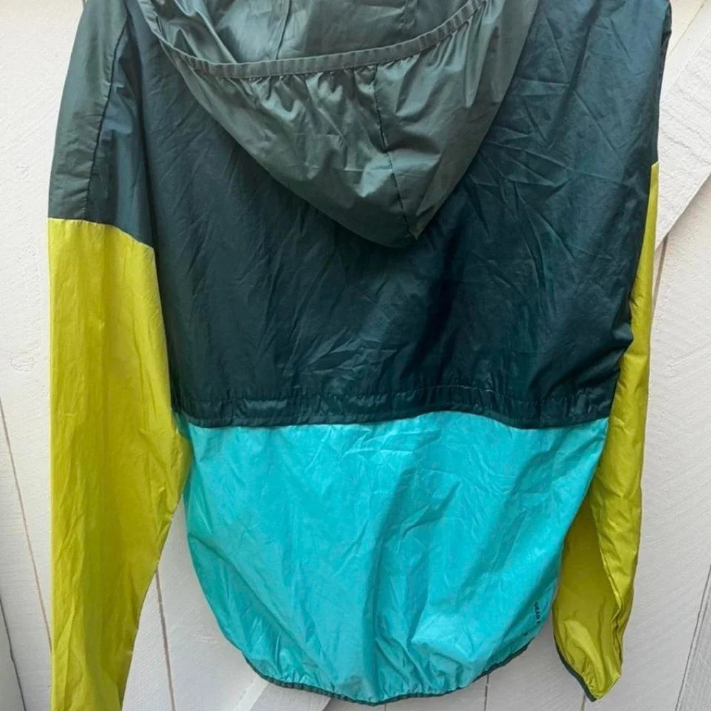Cotopaxi windbreaker with hood jacket in green, yellow, and teal M